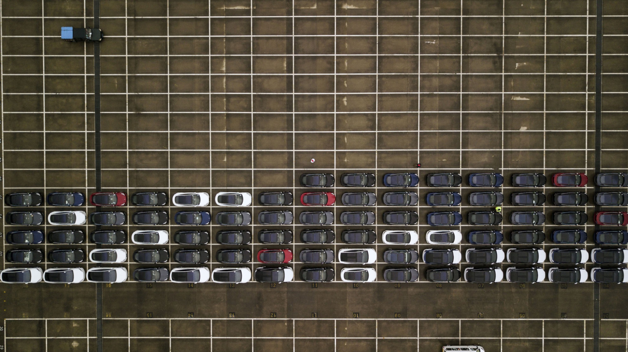 Tesla vehicles sit at a shipping depot after being delivered in Shanghai last February. Amid an unprecedented two-year slump, and now the coronavirus outbreak, hopes are dwindling that China, the world's largest car market, will be able to recover anytime soon. | BLOOMBERG