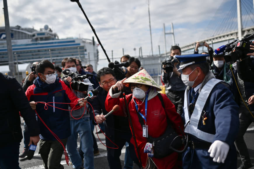 A passenger leaves a port in Yokohama on Wednesday after disembarking the Diamond Princess cruise ship. | AFP-JIJI