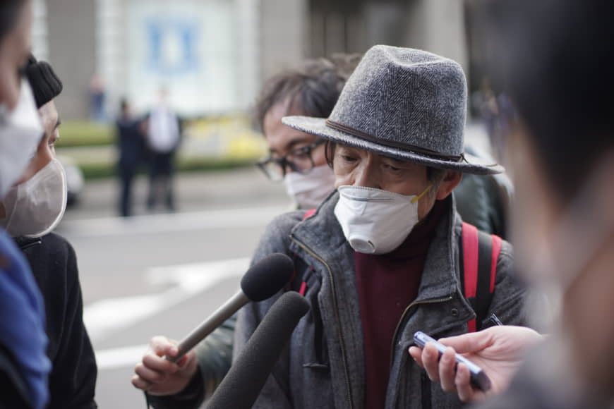 An man in his 70s speaks to the media outside Yokohama Station on Wednesday shortly after disembarking from the Diamond Princess, a cruise ship that had been quarantined in Yokohama for two weeks. | RYUSEI TAKAHASHI.