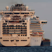 The quarantined cruise ship Diamond Princess is seen anchored off Yokohama on Tuesday. | REUTERS