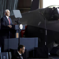 U.S. Vice President Mike Pence speaks to members of the U.S. military and the Self-Defense Forces in front of a U.S. Air Force F-35 fighter at Yokota Airbase in Fussa, Tokyo, in February 2018. | REUTERS