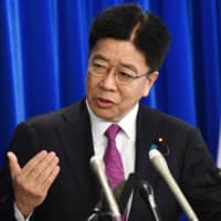 Health minister Katsunobu Kato delivers a speech at a press conference at his ministry in Tokyo on Friday. Hundreds of people have been allowed to leave the ship after testing negative for the disease and many have returned to their home countries to face further quarantine. | AFP-JIJI