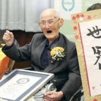 Chitetsu Watanabe, 112, celebrates after receiving a certificate stating he is the world\'s oldest living man from the Guinness World Records on Wednesday in Joetsu, Niigata Prefecture. | POOL / VIA KYODO