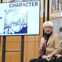 Makoto Tezuka (left) speaks about the manga \"Paidon\" in Tokyo on Wednesday. | KYODO