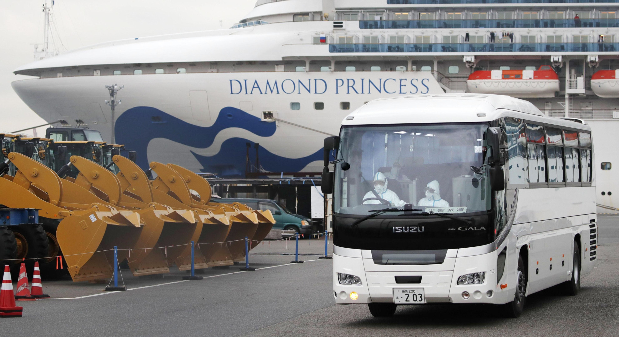 A driver wearing a protective suit is seen inside a bus carrying elderly passengers of the cruise ship Diamond Princess in Yokohama on Friday. | KYODO
