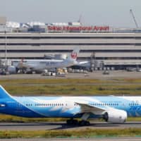 A Boeing 787 jet operated by China Southern Airlines taxis at Haneda Airport in Tokyo. At least 13 regional airports in Japan will completely suspend regular flights to and from mainland China over the novel coronavirus outbreak, they say. | KYODO
