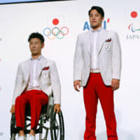 Gold-medal outfits: Athletes model the official uniforms that the Japanese delegation is set to wear at the opening ceremonies of the Tokyo Olympics. | GETTY IMAGES