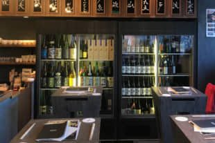 Well-stocked: A wall of sake greets customers at the entrance of LDH Kitchen Izakaya Aobadai. | ROBBIE SWINNERTON