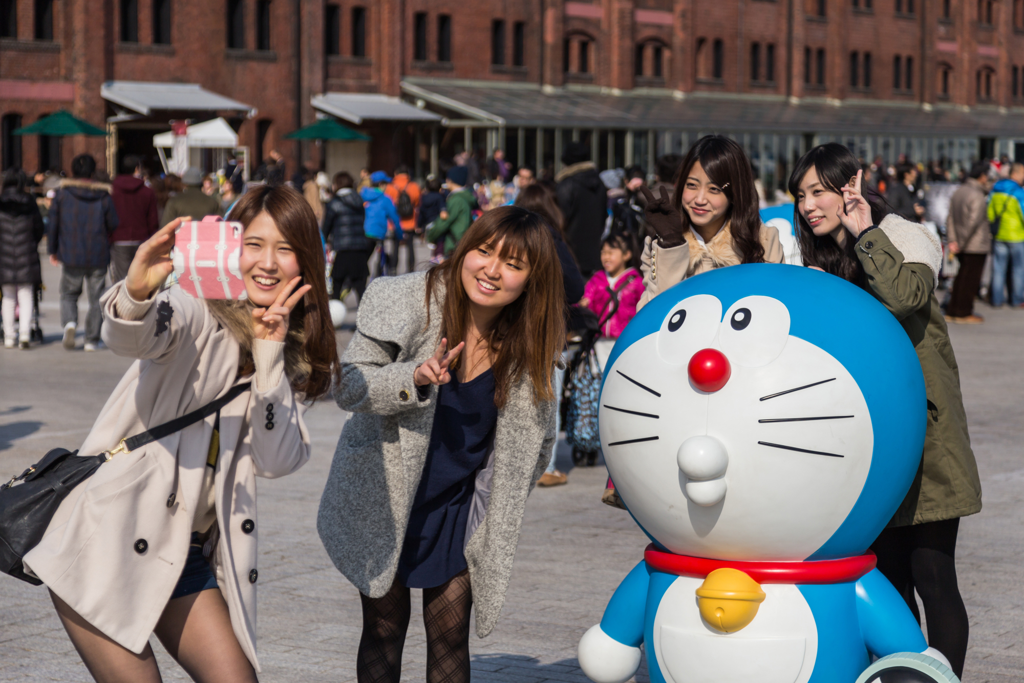 Women take a photo with a Doraemon figure in Yokohama. | GETTY IMAGES