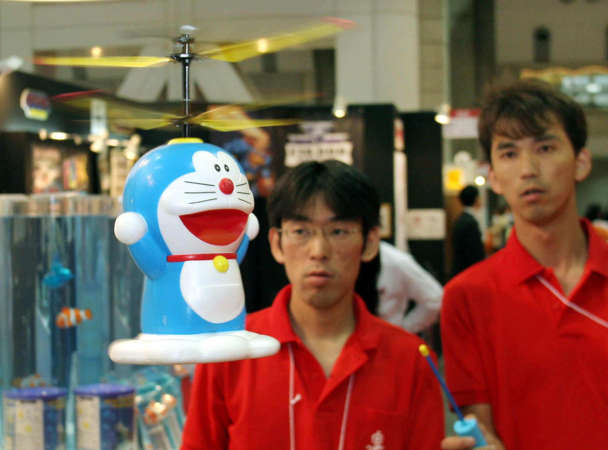 Taiyo Kogyo Co. employees demonstrate a radio-controlled Doraemon helicopter toy. | BLOOMBERG