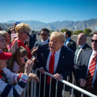 U.S. President Donald Trump speaks with supporters in California on Wednesday. | AFP-JIJI