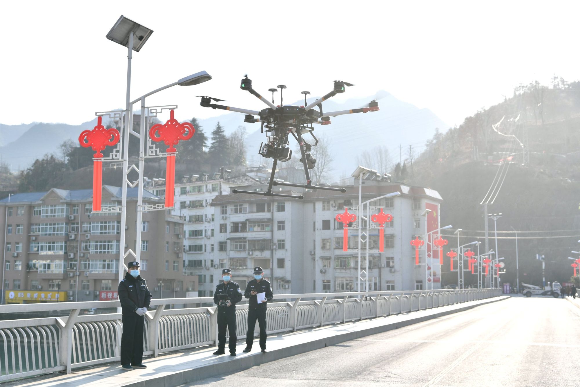 Police officers operate a drone to spread information about the prevention and control of the new coronavirus, in Xiangyang, Hubei province on Feb. 4. | REUTERS