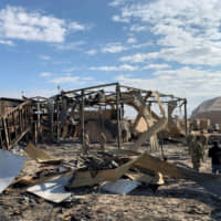 Participants in a Jan. 13 media tour view damage at the al-Asad military base in Iraq following an Iranian missile attack. | AFP-JIJI
