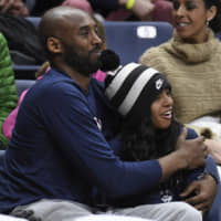Kobe Bryant and his daughter, Gianna, attend a University of Connecticut women\'s basketball game on March 2019 in Storrs, Connecticut. | AP