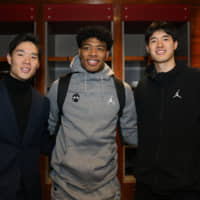 Texas Legends player Yudai Baba (left), Washington Wizards rookie Rui Hachimura and Yuta Watanabe of the Memphis Hustle and Memphis Grizzlies pose for a photo on Friday in Chicago. | CHRIS MARION / NBA