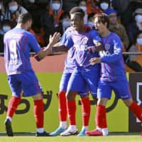 FC Tokyo\'s Adailton (center) celebrates after scoring the team\'s second goal against S-Pulse on Sunday in Shizuoka. | KYODO