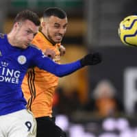 Leicester City\'s Jamie Vardy (left) and Wolverhampton\'s Romain Saiss vie for the ball in a Premier League match on Friday night in Wolverhampton, England. | AFP-JIJI
