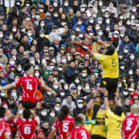 Spectators wear masks during a Top League match at Prince Chichibu Memorial Rugby Ground on Feb. 22. | REUTERS