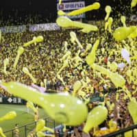 Fans release balloons into the air during a Hanshin Tigers game in August 2019 at Koshien Stadium. | KYODO