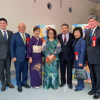 Malaysian Ambassador Dato\' Kennedy Jawan (third from right) and his wife, Datin Josephine Dagang (center) pose with  Mayor Takeshi Sakamoto of the city of Itabashi in Tokyo (right) along with his wife, Takae (second from right) and son, Yoshinori (left); and Mayor Isao Hayashi of  the town of Miyoshi in Saitama Prefecture (second from left) and his wife, Chisato (third from left) at the Embassy of Malaysia\'s New Year\'s reception in Shibuya on Jan. 21. | PHOTO COURTESY OF MALAYSIA EMBASSY