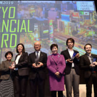 Tokyo Gov. Yuriko Koike (fifth from the left) and winners of the Tokyo Financial Award 2019 at Roppongi Hills for an award ceremony on Feb. 12. From left, for the ESG Investment Category, Yoshiyuki Makino, head of S&amp;P Dow Jones Indices Japan Office; Sayaka Takatsuka and Chunmei Huang, senior directors of the Impact Investment Team, Shinsei Corporate Investment; and Masami Yabumoto, head of Capital Markets Group Investment Banking Business Unit, Mitsubishi UFJ Morgan Stanley Securities Co. For the Financial Innovation Category, Gentaro Tominaga, president and CEO of Frich Co.; Tal Ekroni, CEO and co-founder of Fly Money Technologies; Fumiyasu Kagami, chief operating officer of 400F Co. | YOSHIAKI MIURA