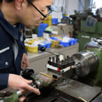 A man works at a factory in Tokyo. Japan faces a possible recession due to the new coronavirus. | BLOOMBERG