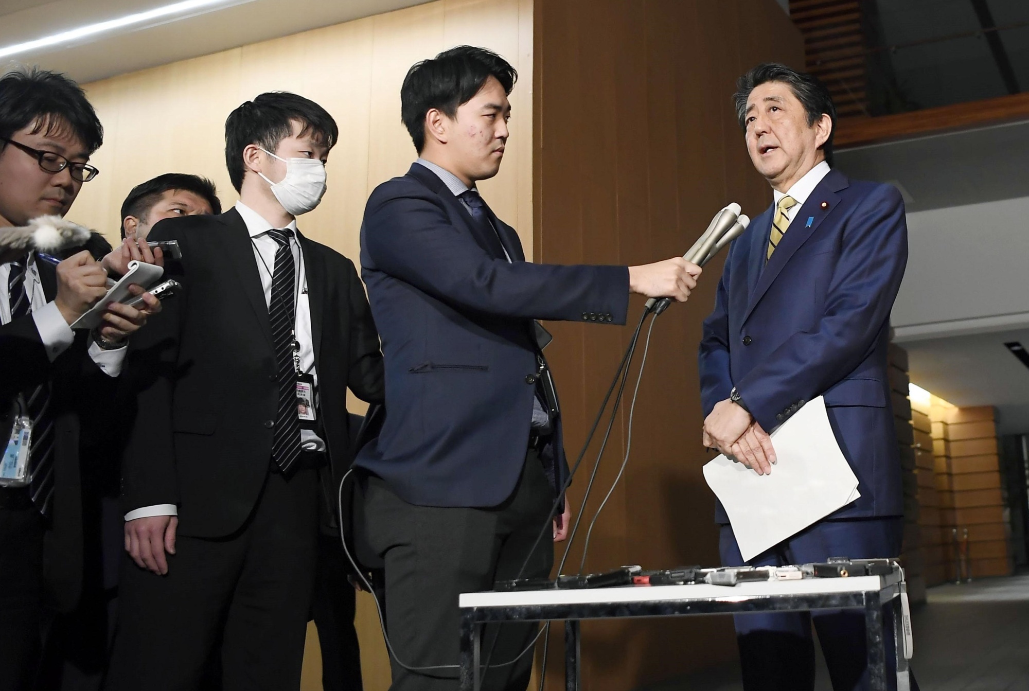 Prime Minister Shinzo Abe speaks to reporters at his office Monday night after talking with Group of Seven leaders in a teleconference. | KYODO