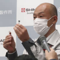 An official at Shimadzu Corp. speaks at a news conference in Kyoto on Wednesday. | KYODO
