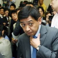 Fund manager Yoshiaki Murakami speaks at a news conference in Tokyo in June 2006. | BLOOMBERG