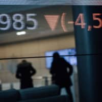 Stock price figures sit reflected in a window in the lobby of the Euronext NV Paris stock exchange in Paris. | BLOOMBERG