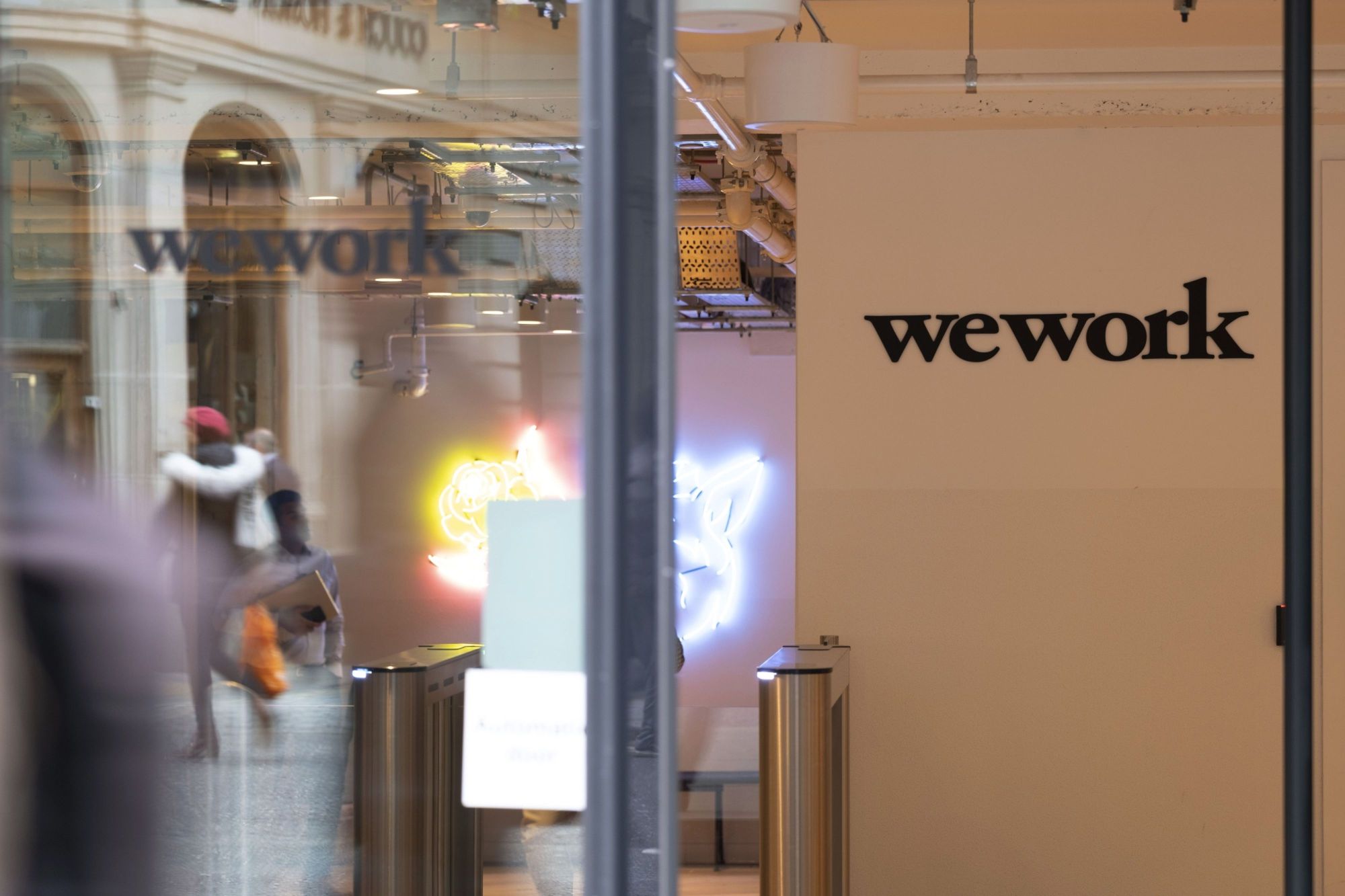 Independent WeWork directors are weighing legal action against SoftBank Group Corp. if it fails to follow through on a rescue package. | BLOOMBERG