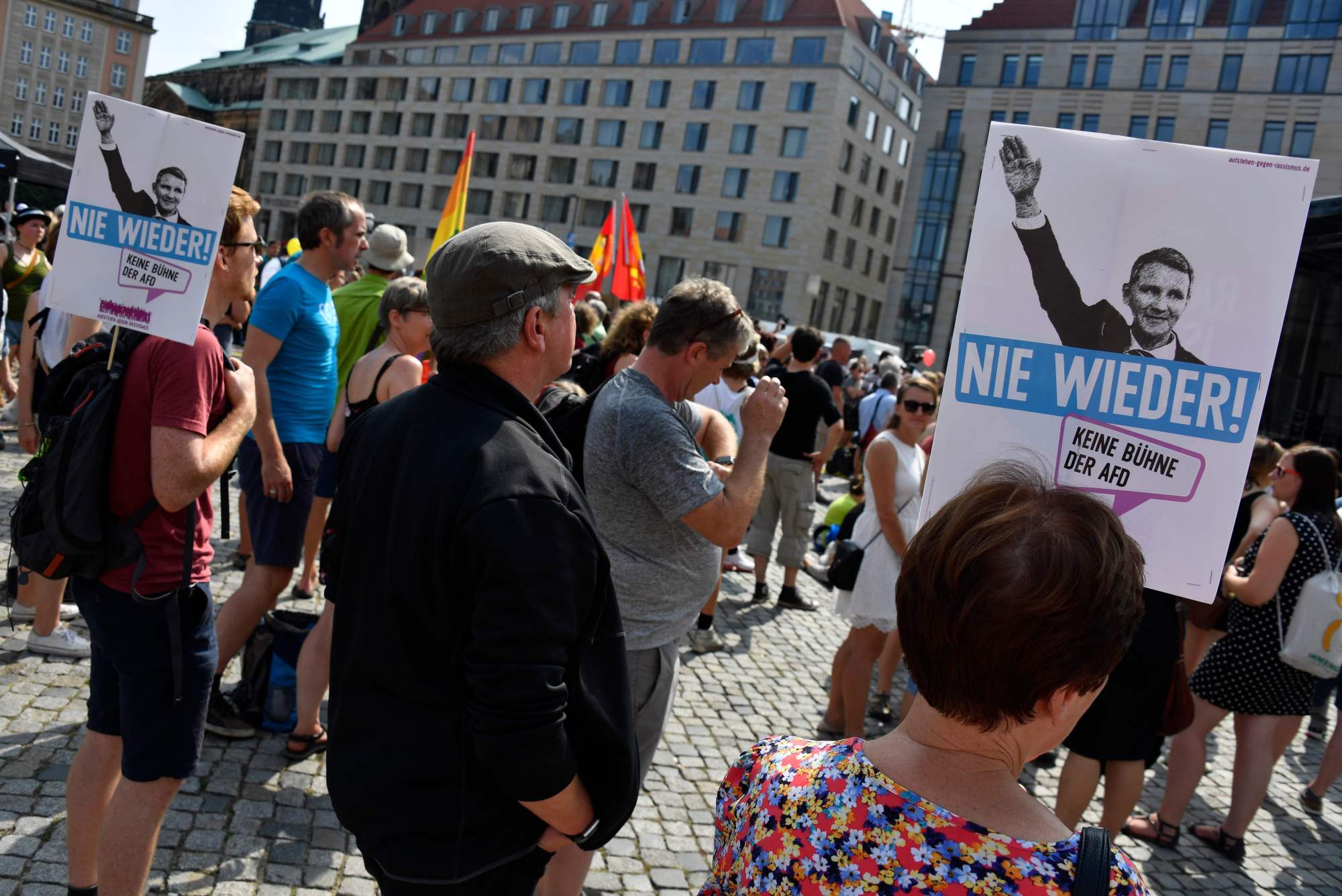 Demonstrators hold posters reading 'Never Again!' and depicting Alternative for Germany (AfD) politician Bjoern Hoecke making a Nazi salute as they attend a protest rally titled 'Unteilbar' ('Indivisible') against exclusion in Dresden, eastern Germany, on August 24, 2019. | AFP-JIJI