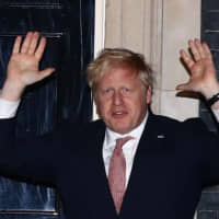 British Prime Minister Boris Johnson applauds outside No. 10 Downing St. during the Clap For Our Carers campaign in support of the NHS on Thursday amid the spread of the new coronavirus. | REUTERS