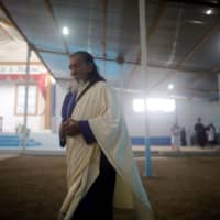 A member of Israelite Mission of the New Universal Pact attends a service on the outskirts of Lima on Feb. 22. | REUTERS