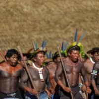 Indigenous men perform during a four-day pow wow in the village of Piaracu in Xingu Indigenous Park in Brazil\'s Mato Grosso state on Jan. 14. | REUTERS