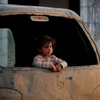 A displaced Syrian girl at an IDP camp near Idlib | REUTERS