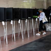 A woman casts her vote during the Florida primary election in Miami on Tuesday. | AFP-JIJI
