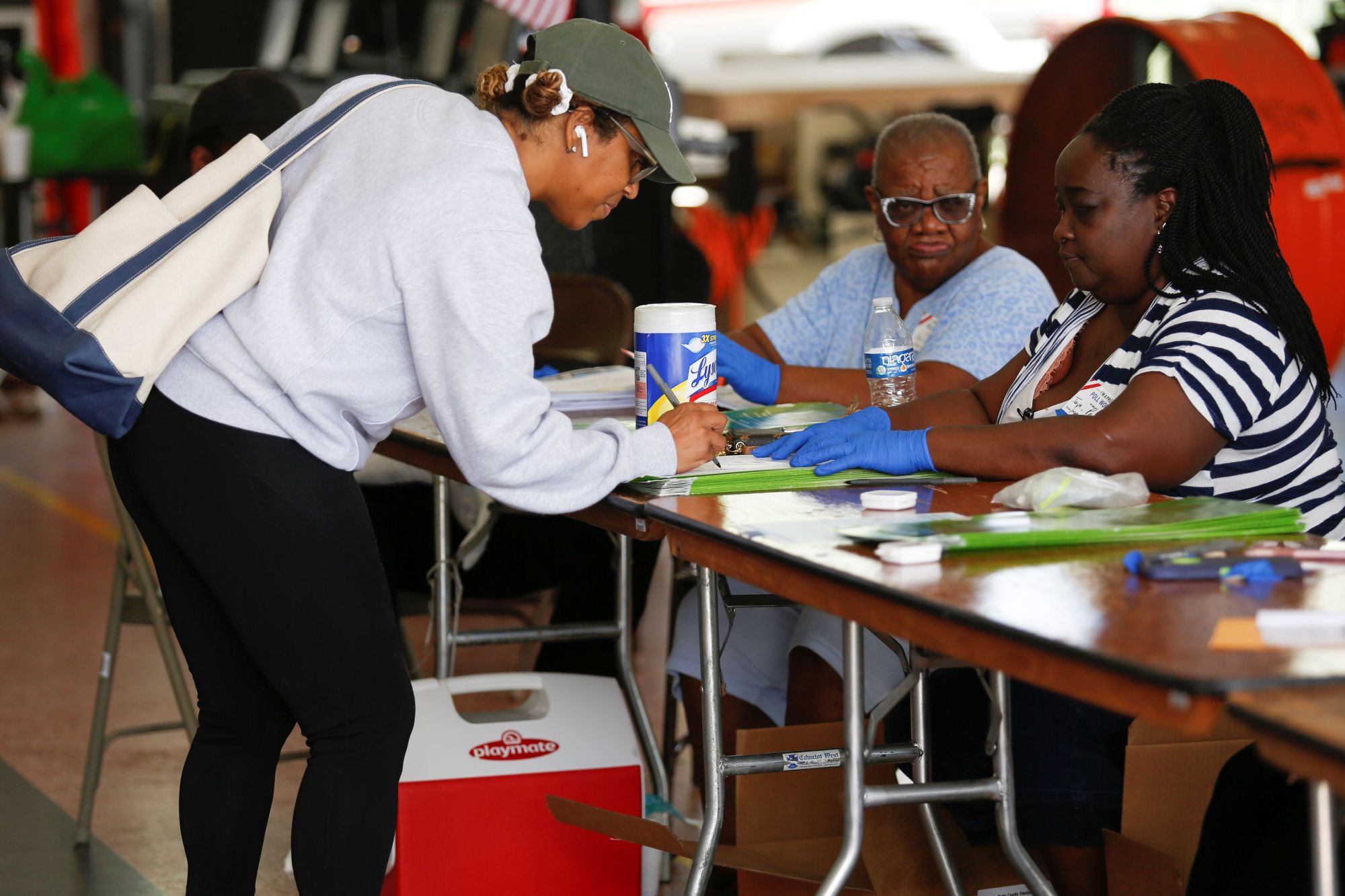A voter signs her ballot before casting her vote at a polling center during the Democratic presidential primary election in Miami on Tuesday. | REUTERS