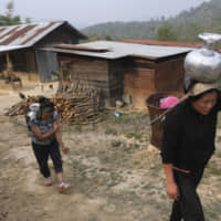 Residents of the village of Shangshak in India\'s northeast Manipurcarry state carry water home on Saturday after finding four springs dry. | AP