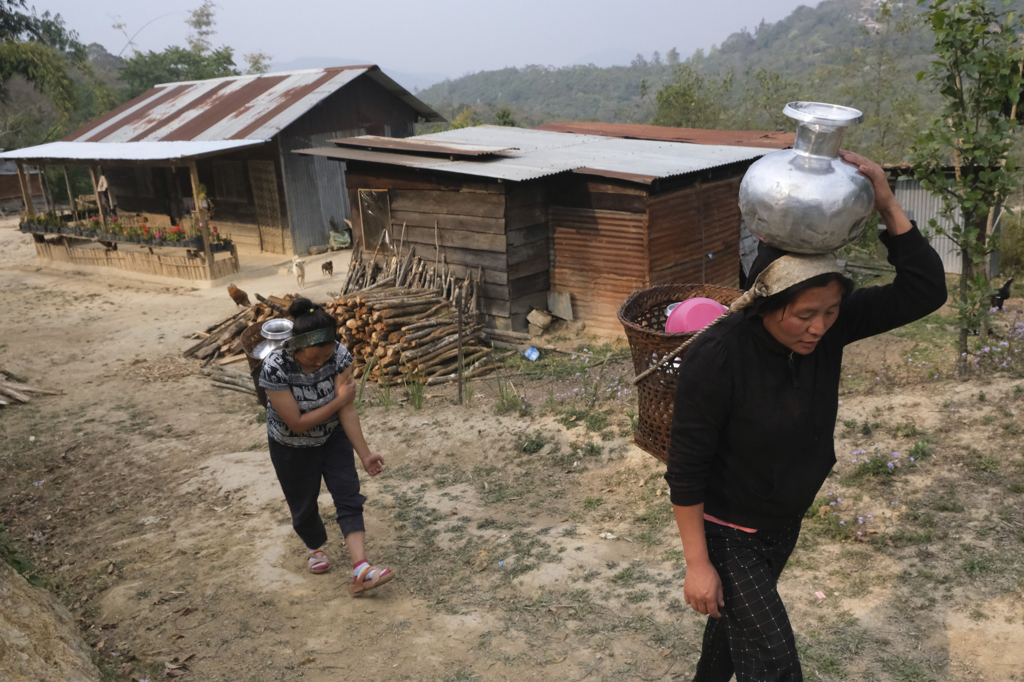 Residents of the village of Shangshak in India's northeast Manipurcarry state carry water home on Saturday after finding four springs dry. | AP