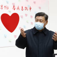 Chinese President Xi Jinping gestures during an inspection of the center for disease control and prevention of Chaoyang District in Beijing in February. | XINHUA / VIA AP