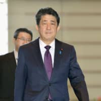 Prime Minister Shinzo Abe enters his office Wednesday morning. | KYODO