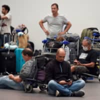 Argentinian passengers remain stranded at Mexico City\'s international airport, on Tuesday. | AFP-JIJI