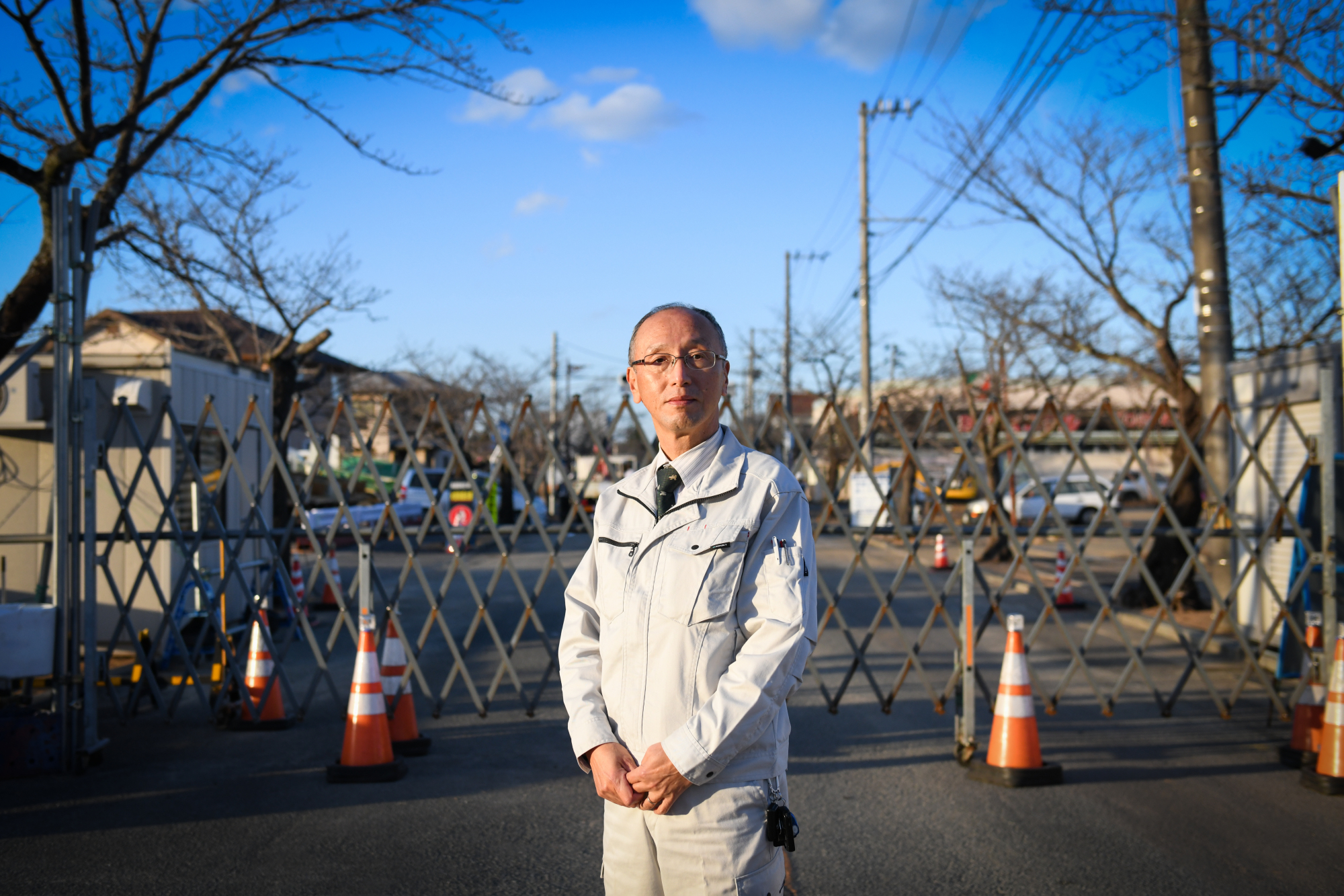 Kiyonori Watanabe, director of Fukushima Electric Power Co., posing outside the 'difficult-to-return' zone in the Yonomori neighborhood of Tomioka, Fukushima Prefecture, says he hopes the region's solar farms will all be taken over by residents, luring additional families home. | BLOOMBERG