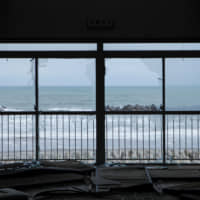 The ocean can be seen through the broken windows of a building damaged by the March 11, 2011, tsunami in Futaba.  | REUTERS