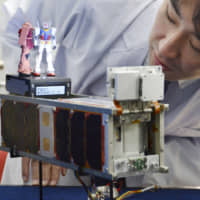 Miniatures of robots like these from the popular anime series \"Mobile Suit Gundam\" have been launched into space from the International Space Station. | KYODO