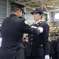 Sgt. Reina Hashiba is awarded the badge of an airborne brigade member at the Ground Self-Defense Force\'s Camp Narashino in Chiba Prefecture on Wednesday. | KYODO