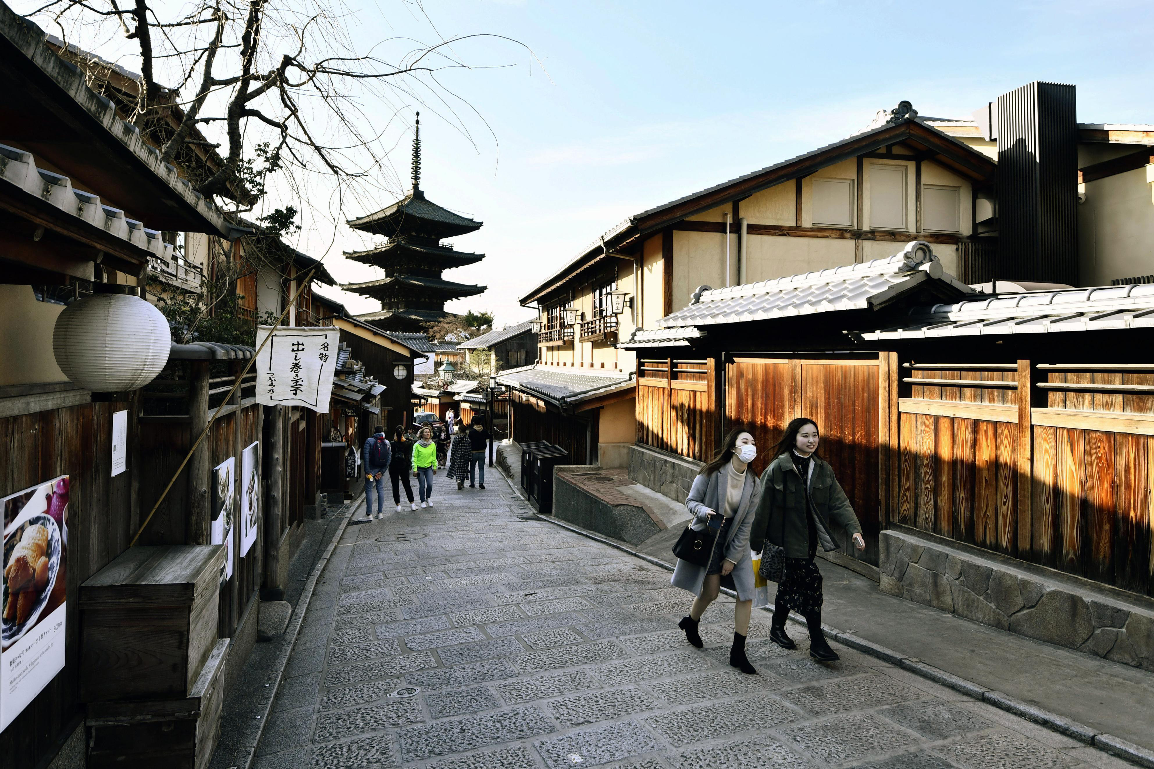 A small number of tourists are seen on a street in historic Kyoto. | KYODO