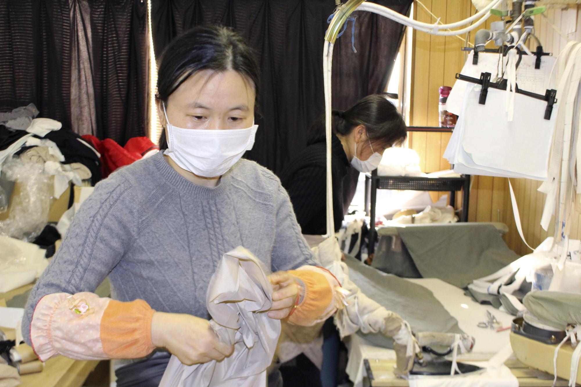 A Chinese trainee works at a sewing factory in the city of Gifu on Tuesday. Many Chinese workers haven't been able to start their training programs in Japan due to entry restrictions linked to the new coronavirus, causing a labor shortage in several sectors. | KYODO