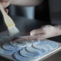 Handle with care: Shiho Sakamoto gently brushes discs of mochi dough before shaping them into wagashi sweets. | HUE INC.
